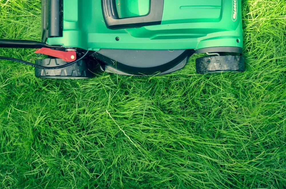 Lawn Mower over green grass mowing